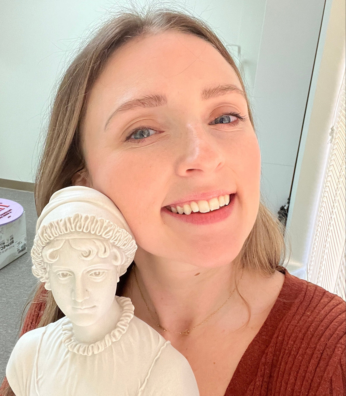 Hailee smiling with a small Jane Austen bust statue